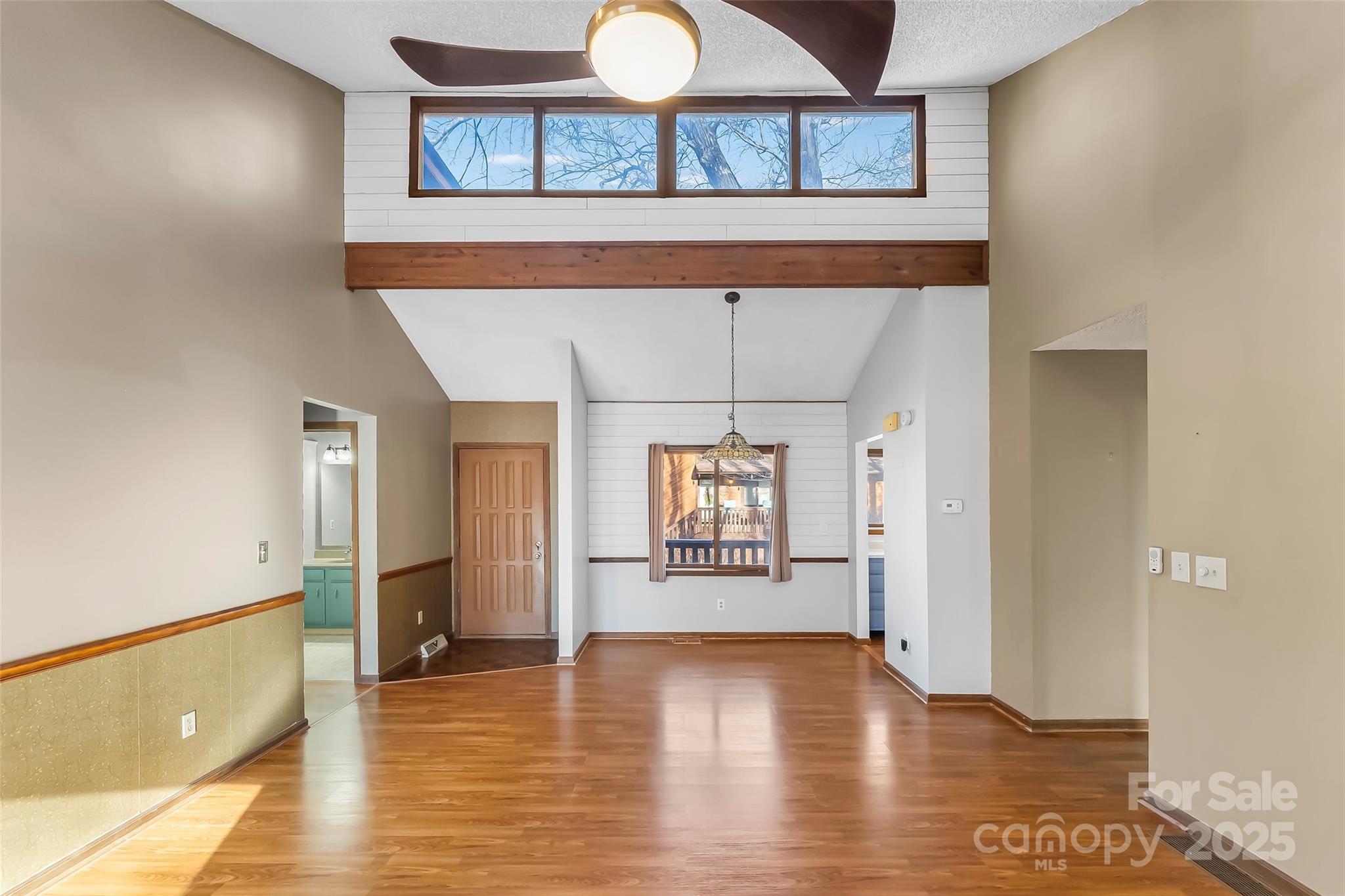 39 Oak Court Fletcher, NC 28732 - Photo 7 of 41 a view of a big room with wooden floor and windows