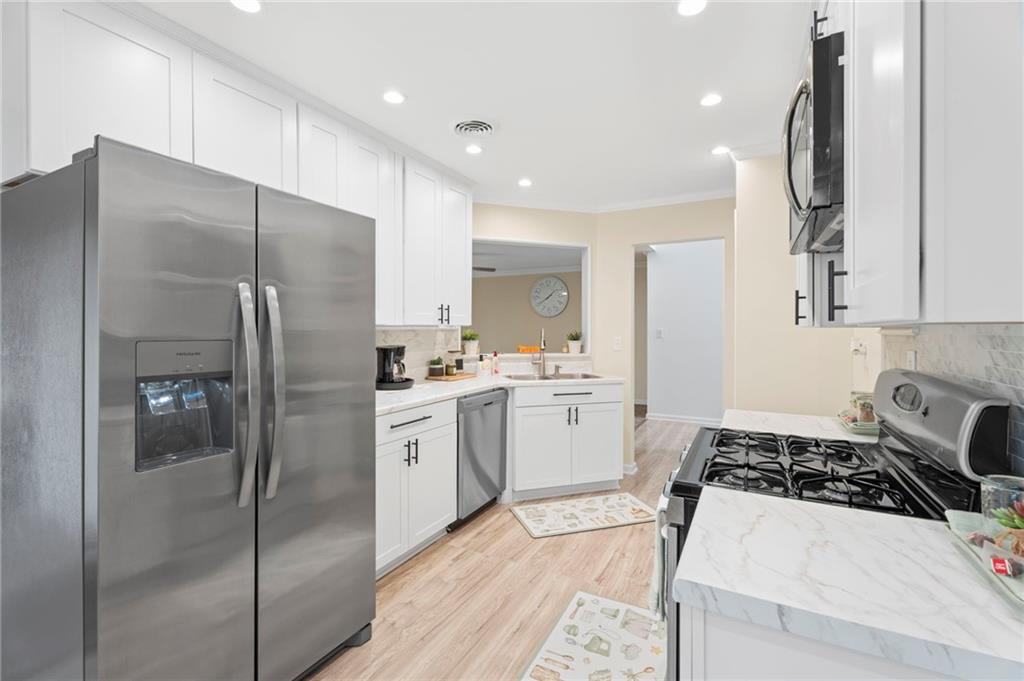 3292 Basking Shade Lane Decatur, GA 30034 - Photo 11 of 57 a kitchen with a refrigerator a sink and cabinets