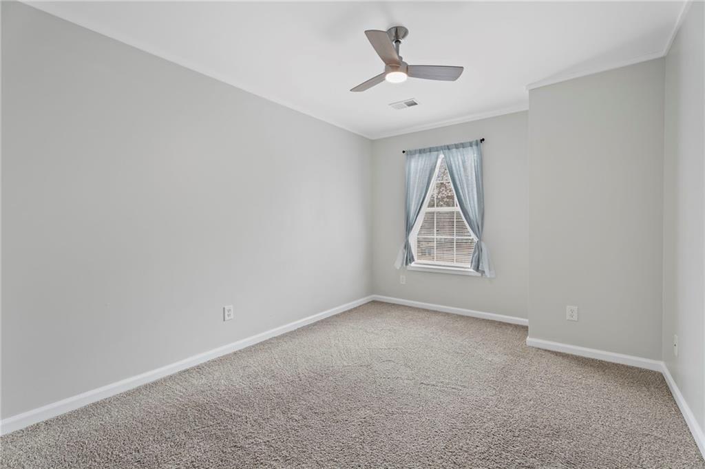 3292 Basking Shade Lane Decatur, GA 30034 - Photo 27 of 57 an empty room with chandelier fan and windows