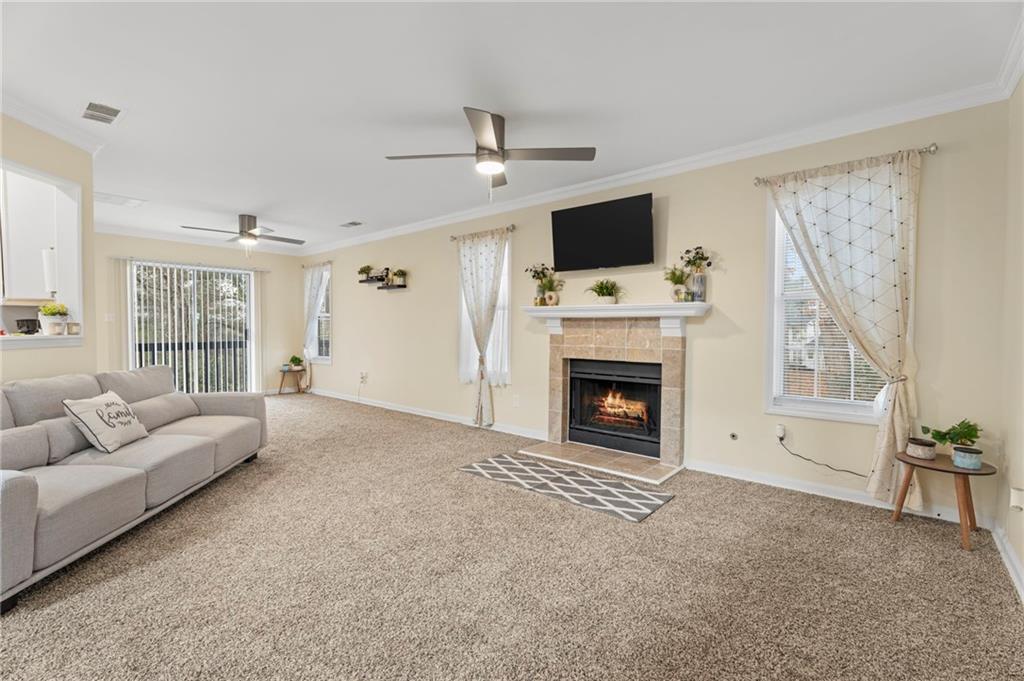 3292 Basking Shade Lane Decatur, GA 30034 - Photo 6 of 57 a living room with furniture a flat screen tv and a fireplace