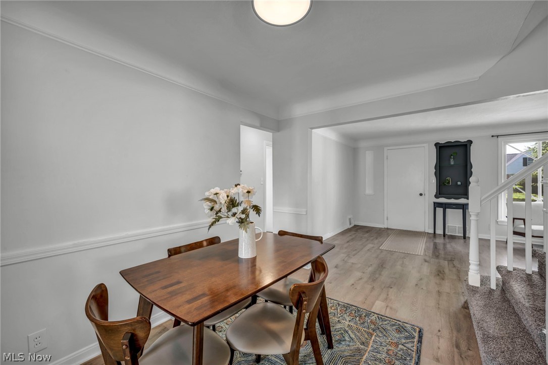 4117 Wyncote Road South Euclid, OH 44121 - Photo 21 of 50 Dining area featuring wood-finish flooring, crown molding, and chair rail detailing