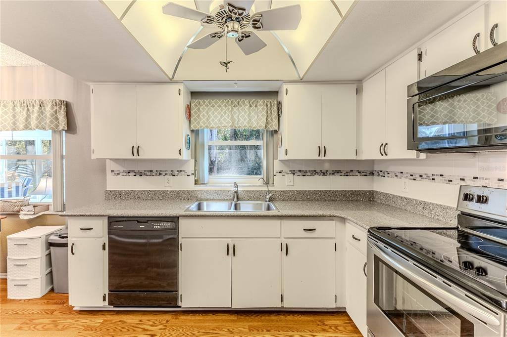 6375 Ocean Pines Lane Spring Hill, FL 34606 - Photo 17 of 50 a kitchen with a sink cabinets and window