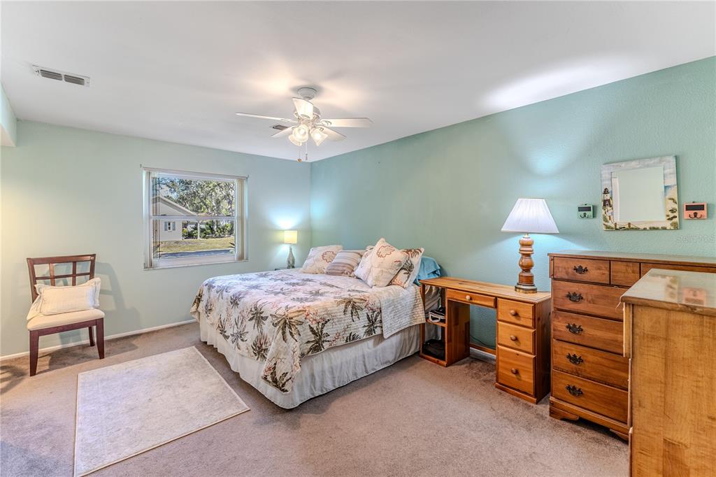 6375 Ocean Pines Lane Spring Hill, FL 34606 - Photo 24 of 50 a bed room with a bed and a lamp on a dresser