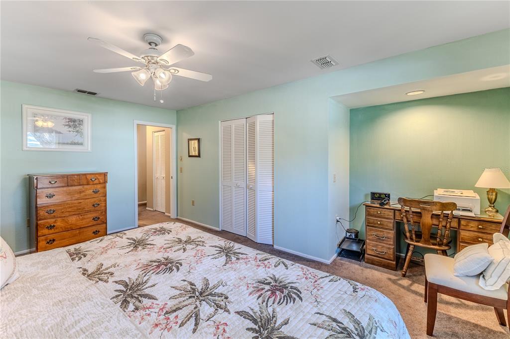 6375 Ocean Pines Lane Spring Hill, FL 34606 - Photo 25 of 50 a bedroom with a bed and a chandelier
