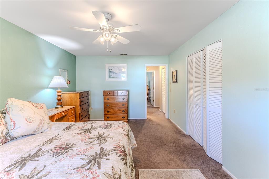 6375 Ocean Pines Lane Spring Hill, FL 34606 - Photo 26 of 50 a bedroom with a large bed and a chandelier