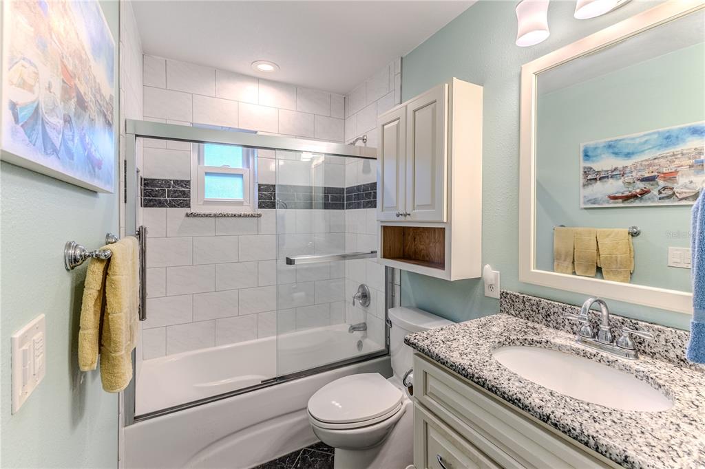 6375 Ocean Pines Lane Spring Hill, FL 34606 - Photo 27 of 50 a bathroom with a granite countertop sink toilet and shower