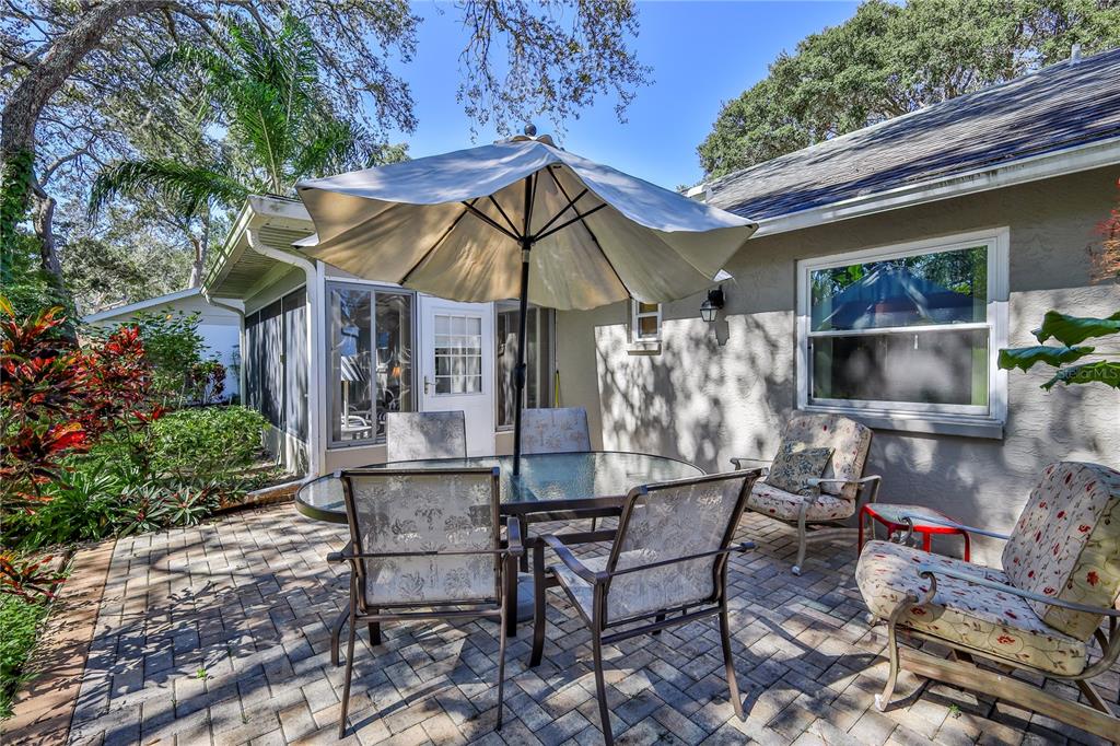 6375 Ocean Pines Lane Spring Hill, FL 34606 - Photo 33 of 50 a patio with a table and chairs under an umbrella