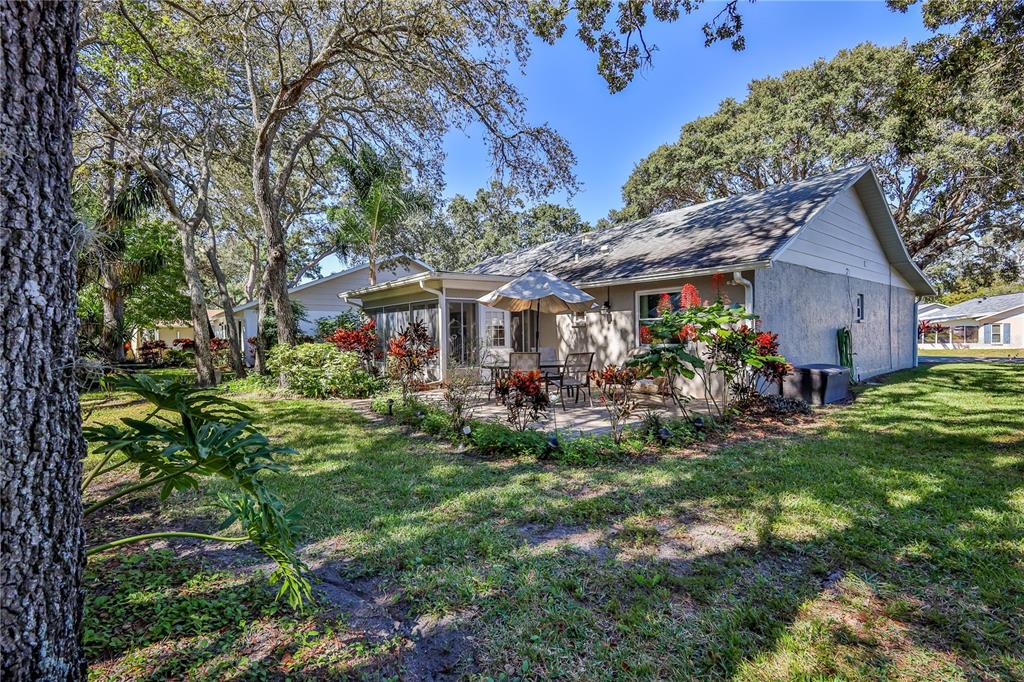 6375 Ocean Pines Lane Spring Hill, FL 34606 - Photo 38 of 50 a front view of a house with a garden