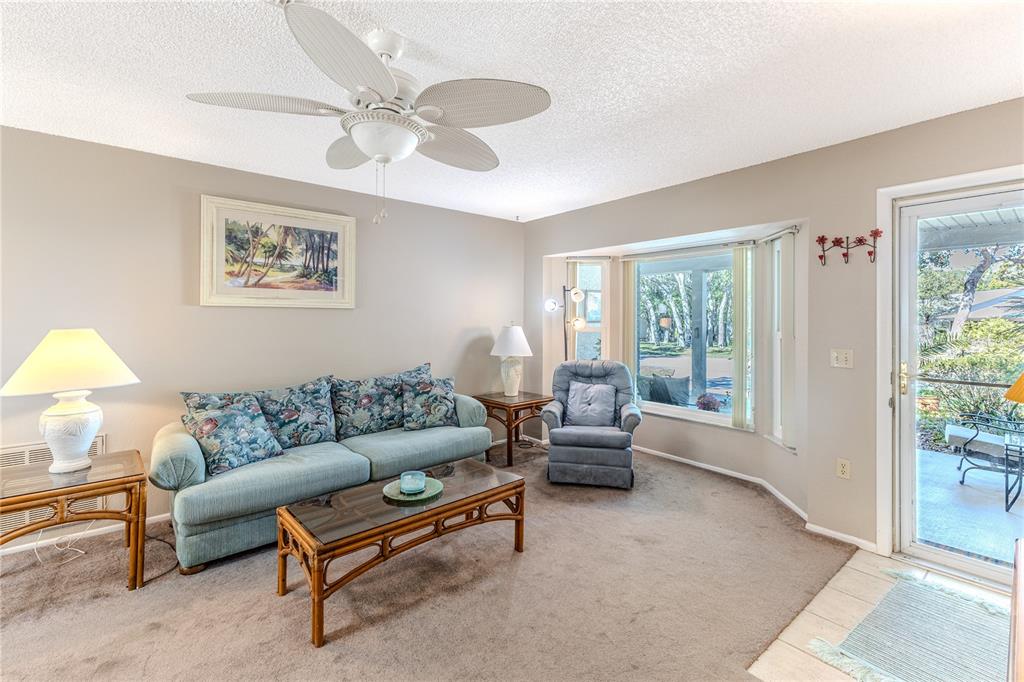 6375 Ocean Pines Lane Spring Hill, FL 34606 - Photo 9 of 50 a living room with furniture and a large window