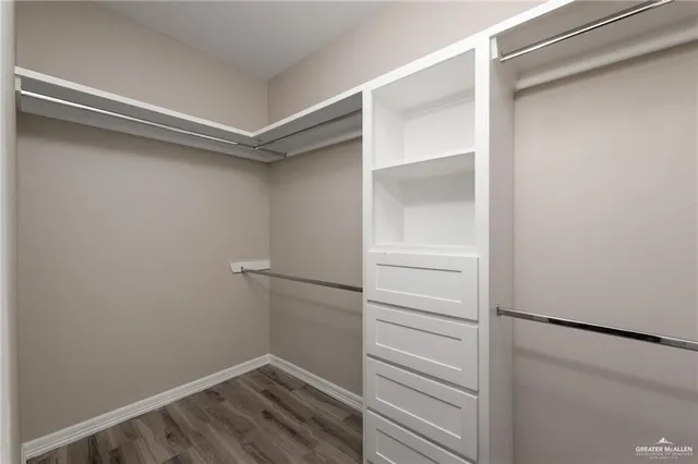a view of walk in closet with empty racks