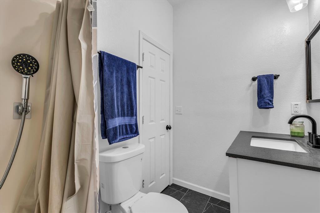 1209 Southey Street Waco, TX 76704 - Photo 7 of 21 a bathroom with a sink a toilet and shower
