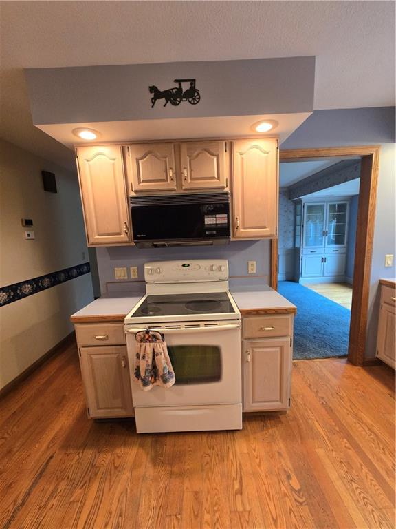 205 Hamburg Road Greenville, PA 16125 - Photo 7 of 39 a kitchen with a stove and wooden floor