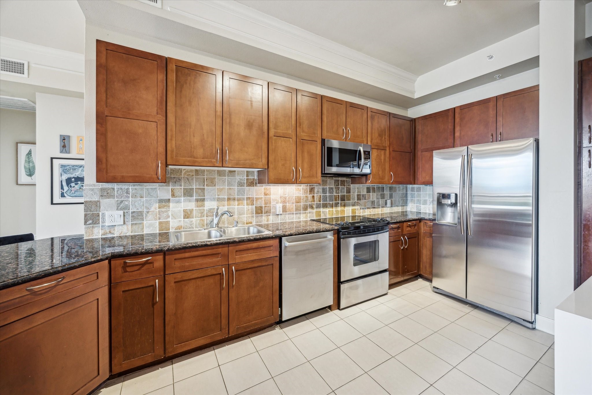 3333 Allen Parkway, Unit 1004 Houston, TX 77019 - Photo 9 of 36 a kitchen with stainless steel appliances granite countertop a refrigerator and a stove top oven