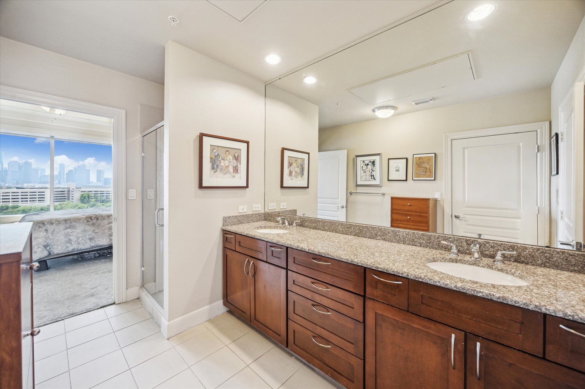3333 Allen Parkway, Unit 1004 Houston, TX 77019 - Photo 14 of 36 a spacious bathroom with a granite countertop sink a mirror and a shower