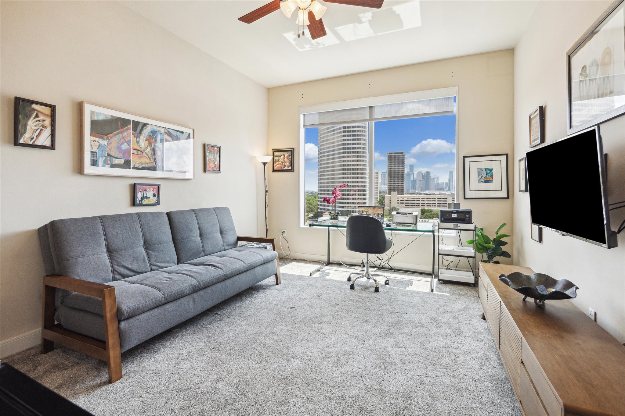 3333 Allen Parkway, Unit 1004 Houston, TX 77019 - Photo 17 of 36 a living room with furniture a flat screen tv and kitchen view