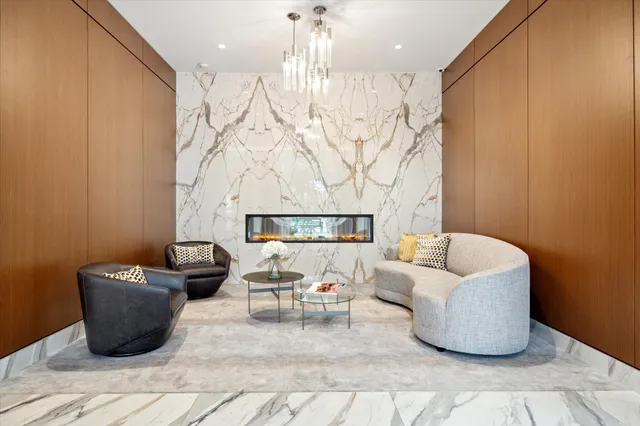 a living room with furniture and a chandelier