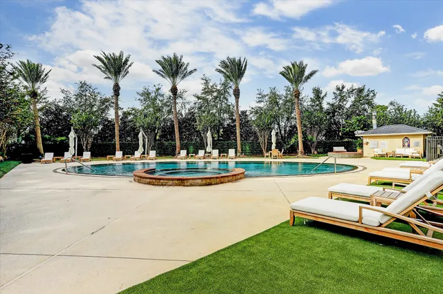 a view of swimming pool with outdoor seating and plants