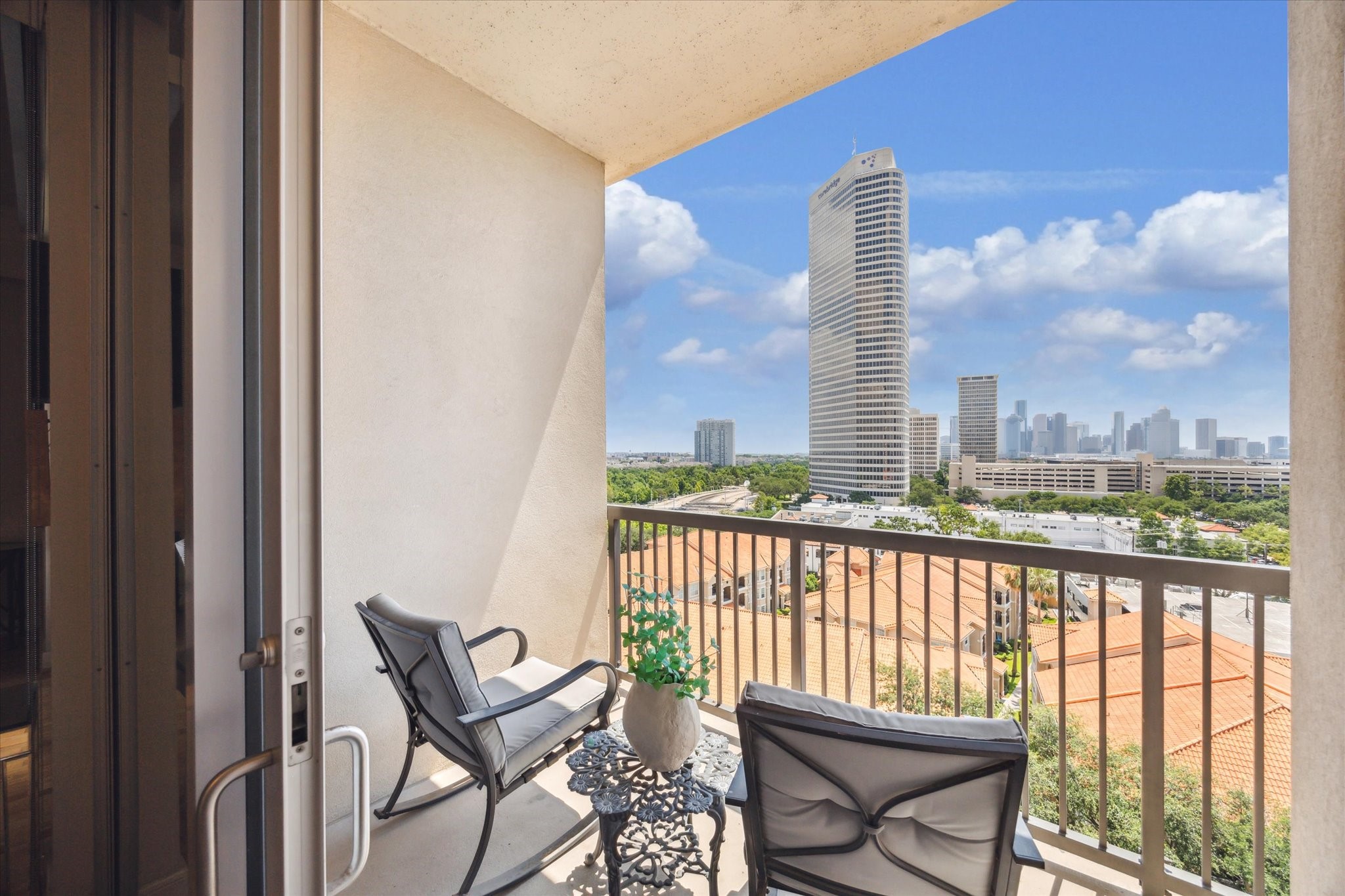 3333 Allen Parkway, Unit 1004 Houston, TX 77019 - Photo 2 of 36 a view of a city from a balcony with furniture
