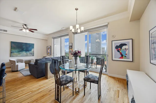 a view of a dining room with furniture wooden floor and a chandelier