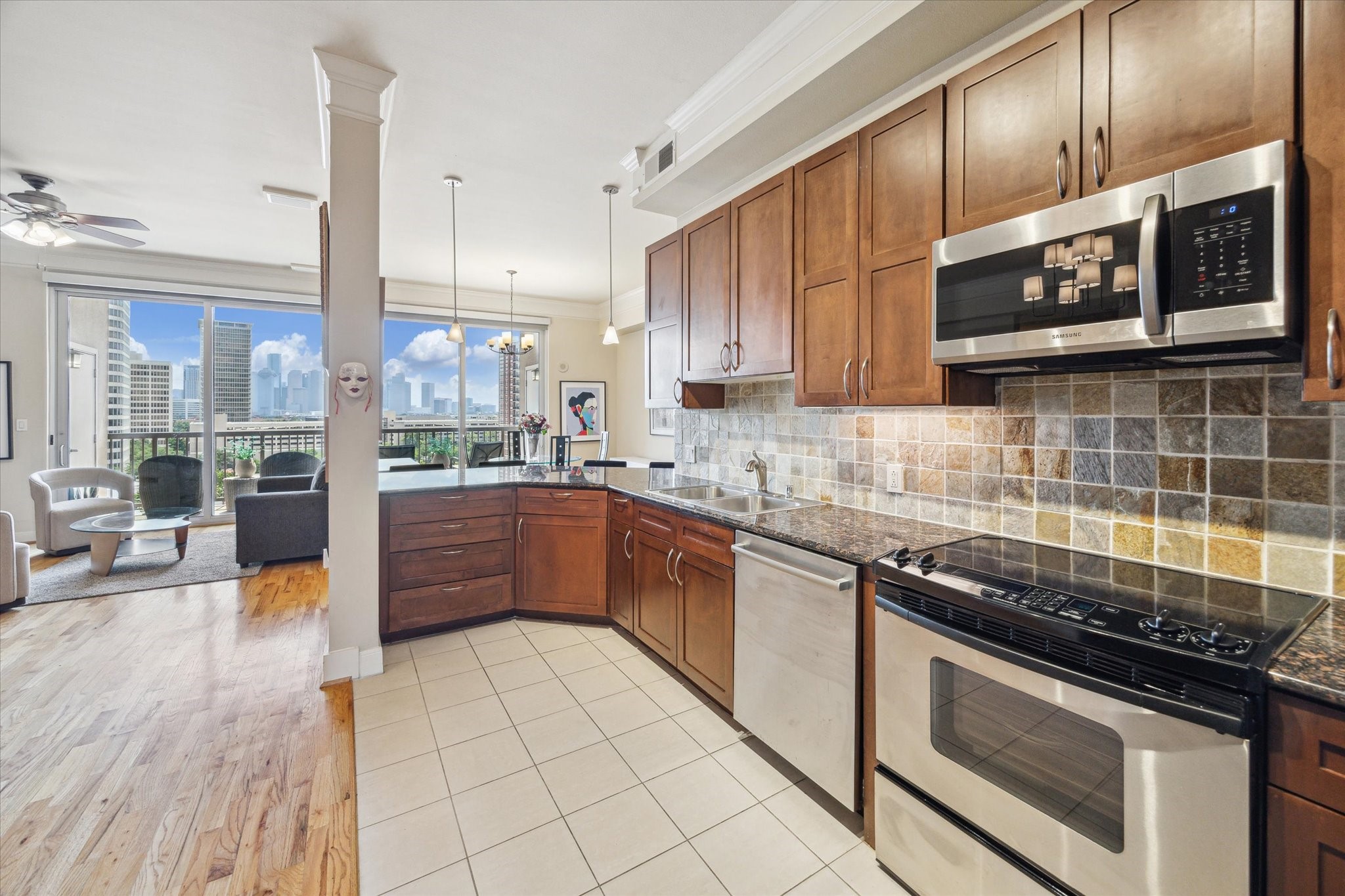 3333 Allen Parkway, Unit 1004 Houston, TX 77019 - Photo 8 of 36 a kitchen with stainless steel appliances granite countertop a stove a sink and a microwave