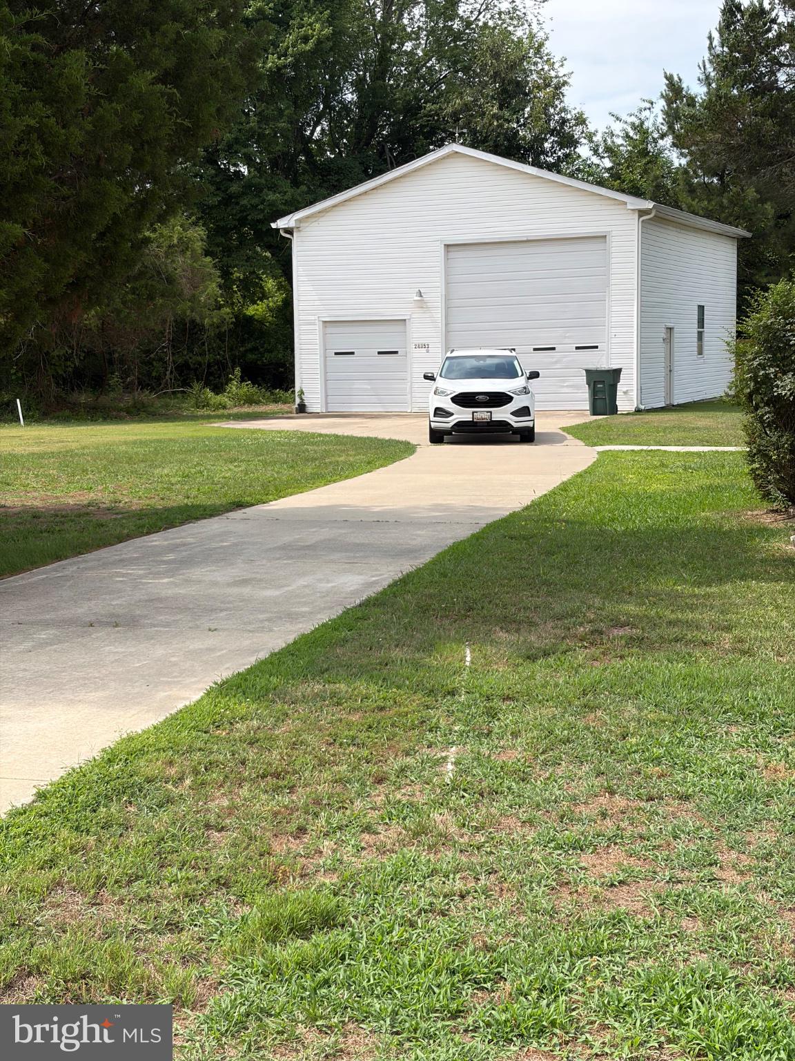 Charming driveway leads to a spacious garage.