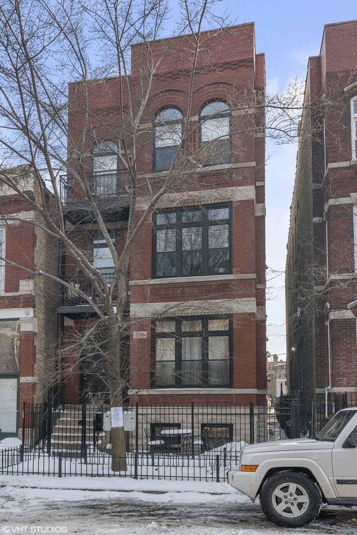 1735 West Erie Street, Unit 1N Chicago, IL 60622 - Photo 2 of 18 a front view of a building with parking space