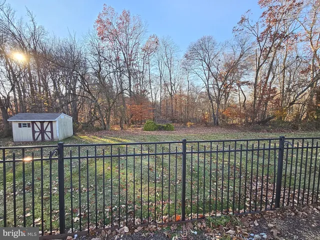 a view of a brick house with a large trees