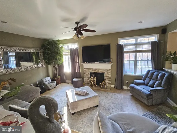 a living room with furniture a fireplace and a flat screen tv