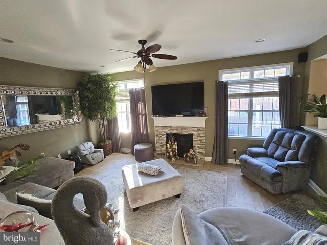 a living room with furniture a fireplace and a flat screen tv