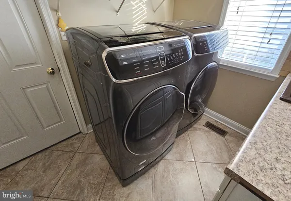 a utility room with dryer and washer