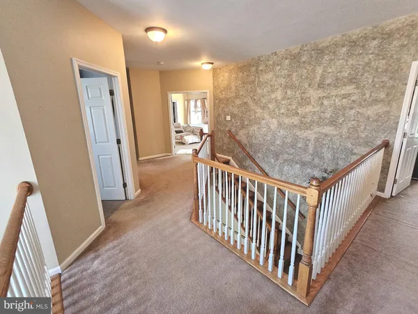 a bedroom with bed and a large mirror