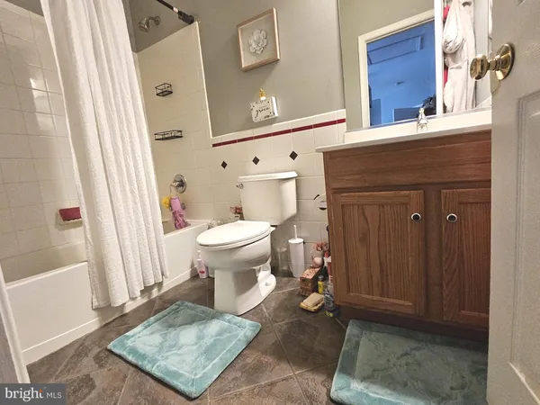 a white toilet sitting next to a bathroom sink