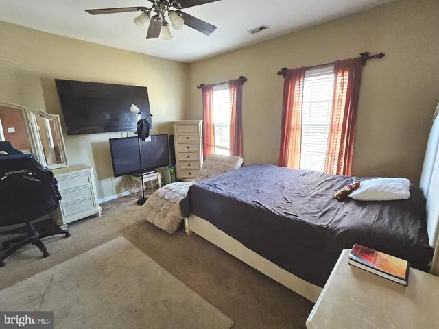 a bedroom with a bed dresser and a window