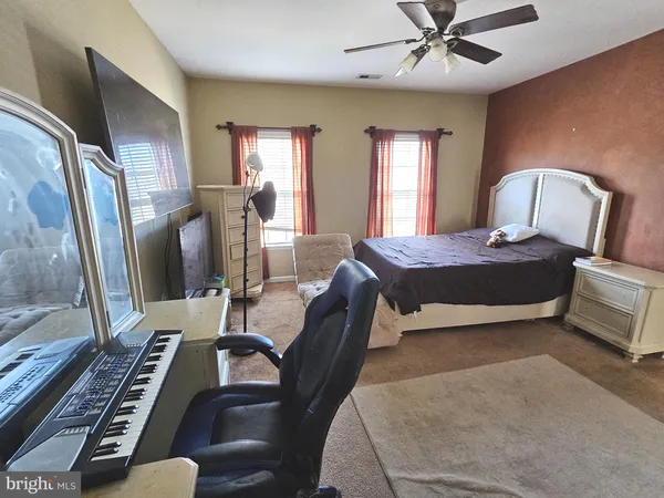 a view of a hallway with a livingroom and a bathroom