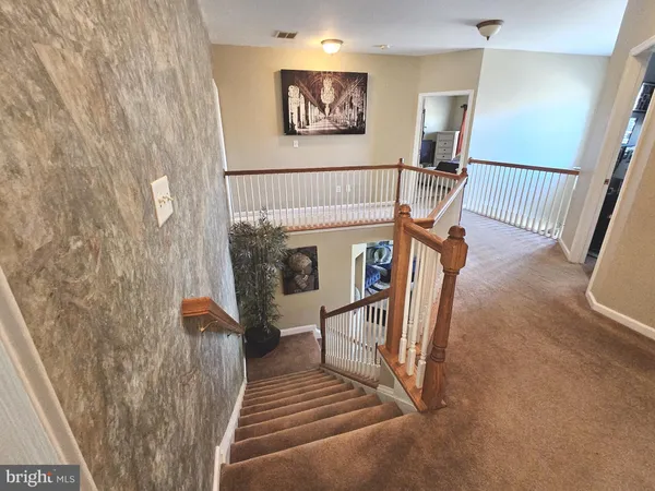 a view of entryway with a rug and a living room