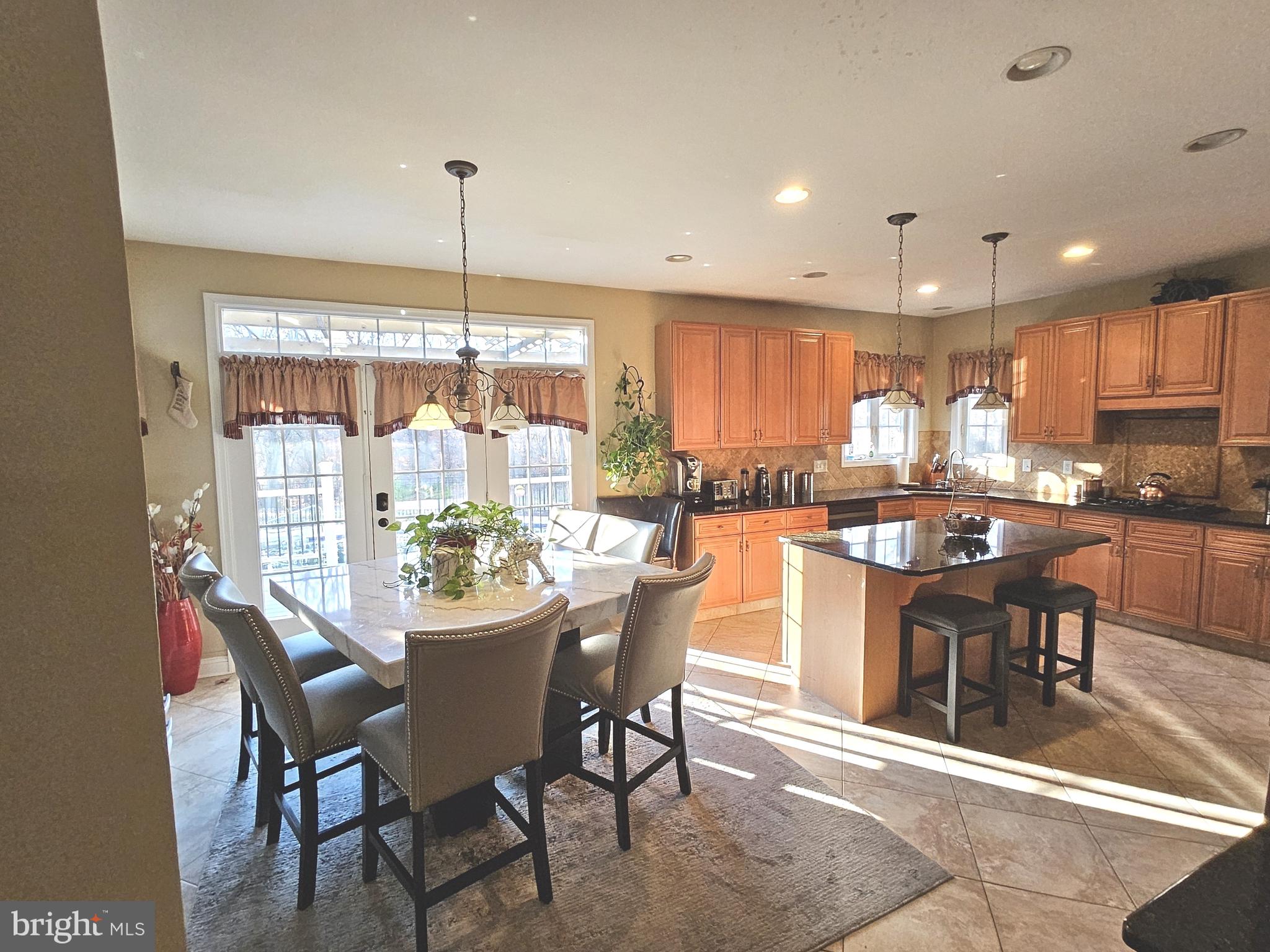 624 Nesting Lane Middletown, DE 19709 - Photo 10 of 50 a dining area with a table chairs and a floor to ceiling window