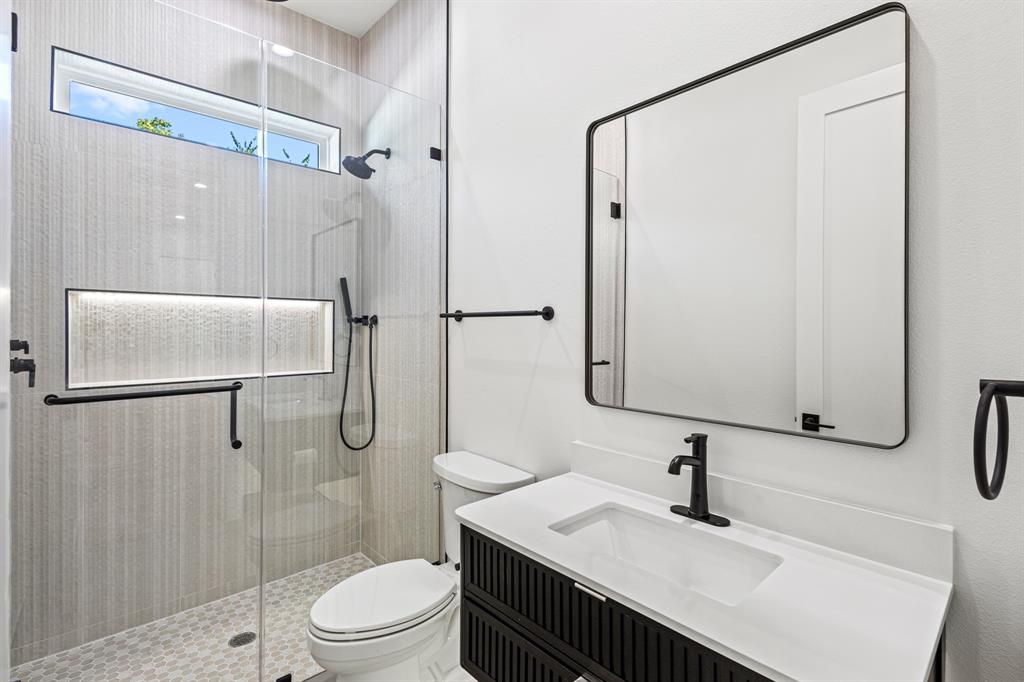 4016 Baker Avenue Dallas, TX 75212 - Photo 31 of 38 a bathroom with a sink toilet a mirror and shower