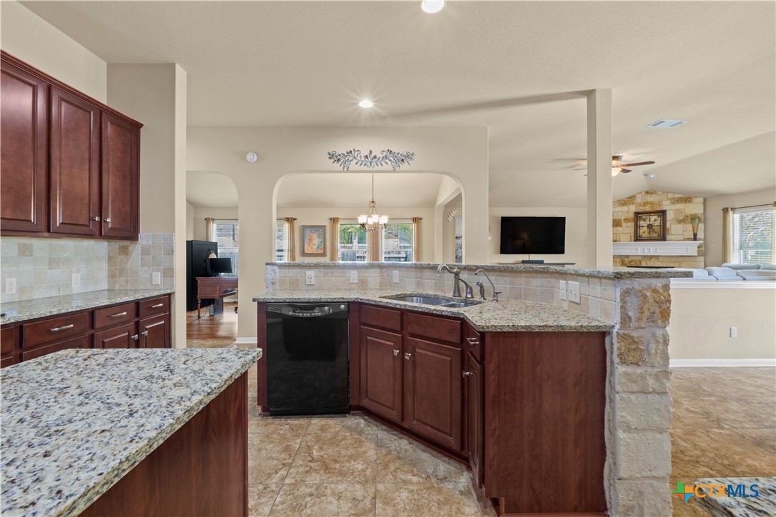 20525 Jackies Ranch Boulevard Pflugerville, TX 78660 - Photo 30 of 30 Kitchen featuring open floor plan, recessed lighting, sturdy granite countertops, and tasteful backsplash