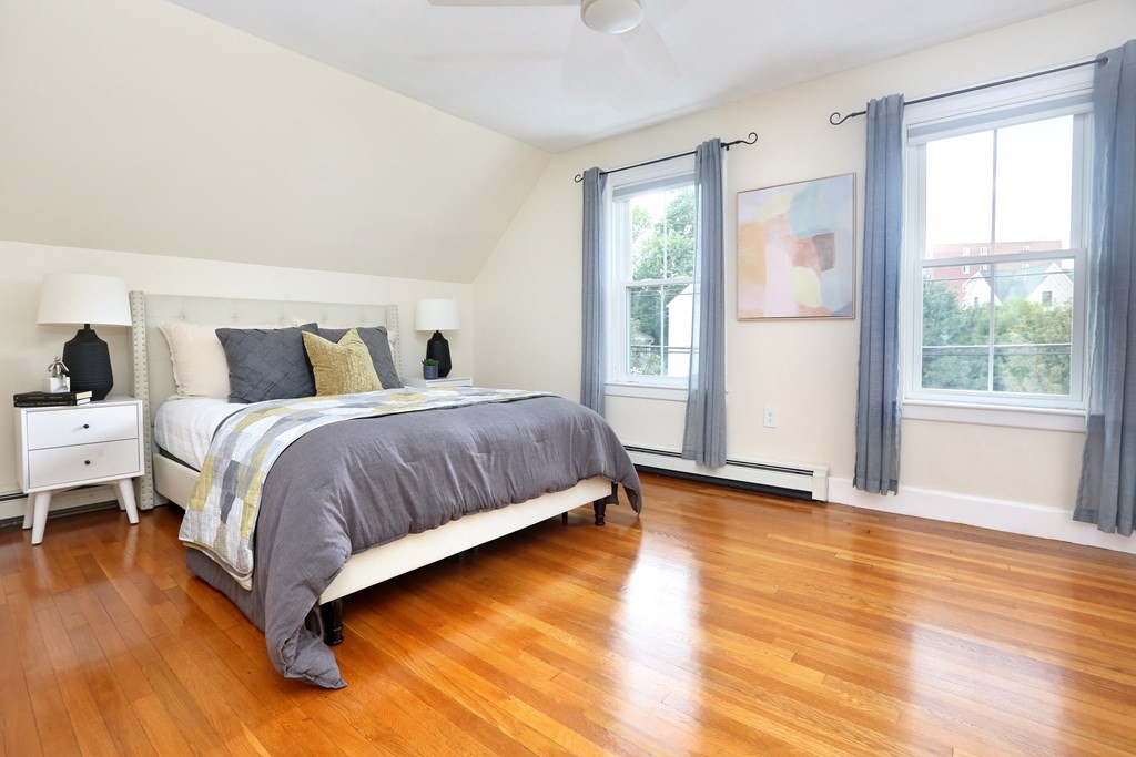 195 Fayette Street Watertown, MA 02472 - Photo 11 of 18 a bedroom with a bed and wooden floor
