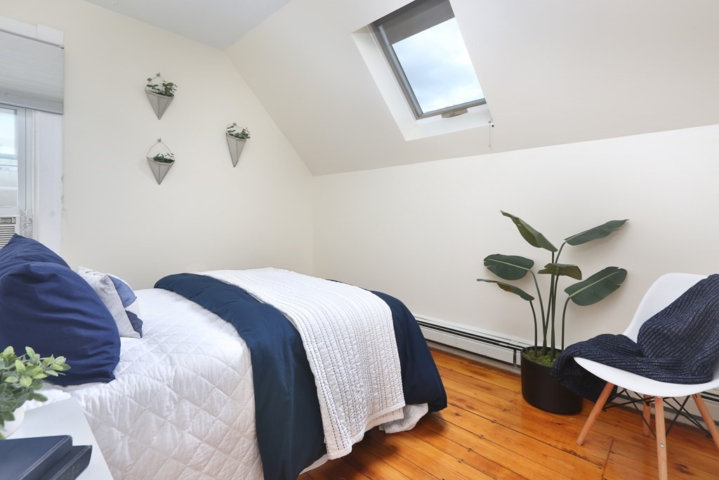195 Fayette Street Watertown, MA 02472 - Photo 13 of 18 a bedroom with a bed and wooden floor