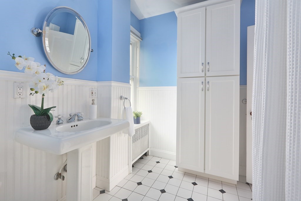 195 Fayette Street Watertown, MA 02472 - Photo 10 of 18 a bathroom with a sink and a mirror