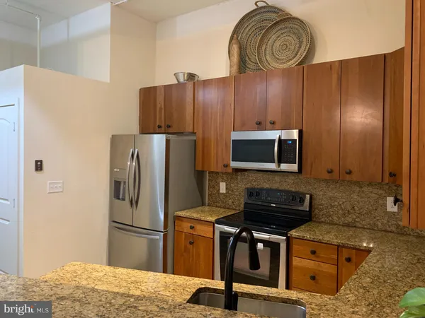 a kitchen with a stove a sink and a microwave