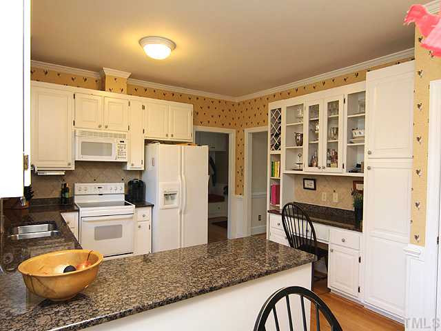 2512 Ashley Court Raleigh, NC 27607 - Photo 6 of 24 Kitchen is the link to family room, dining room, and also the utiliy area that you can see at the far end of this picture. Kitchen
