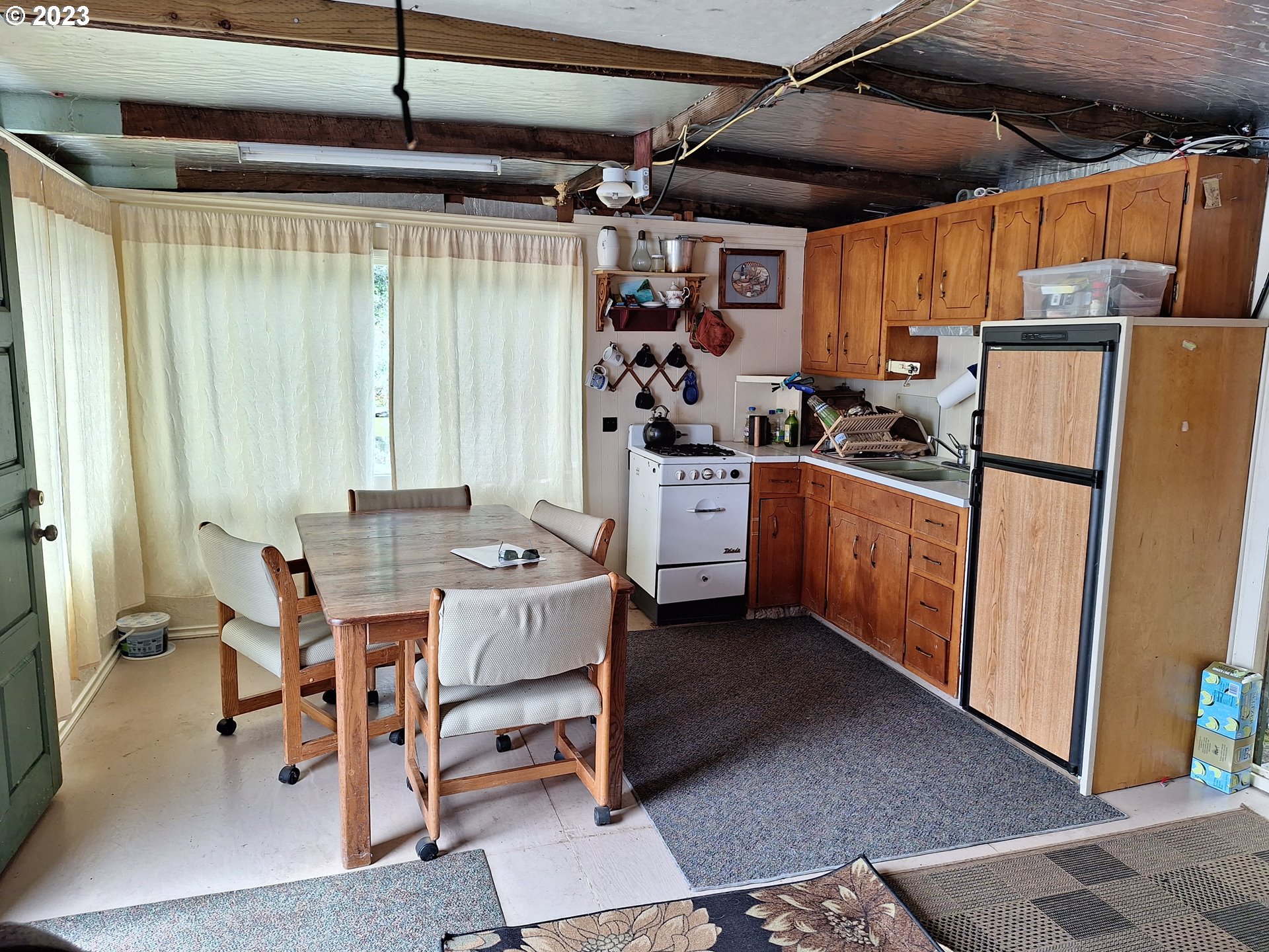 Tahkenitch Gardiner, OR 97441 - Photo 11 of 12 a kitchen with stainless steel appliances granite countertop a table chairs and a refrigerator