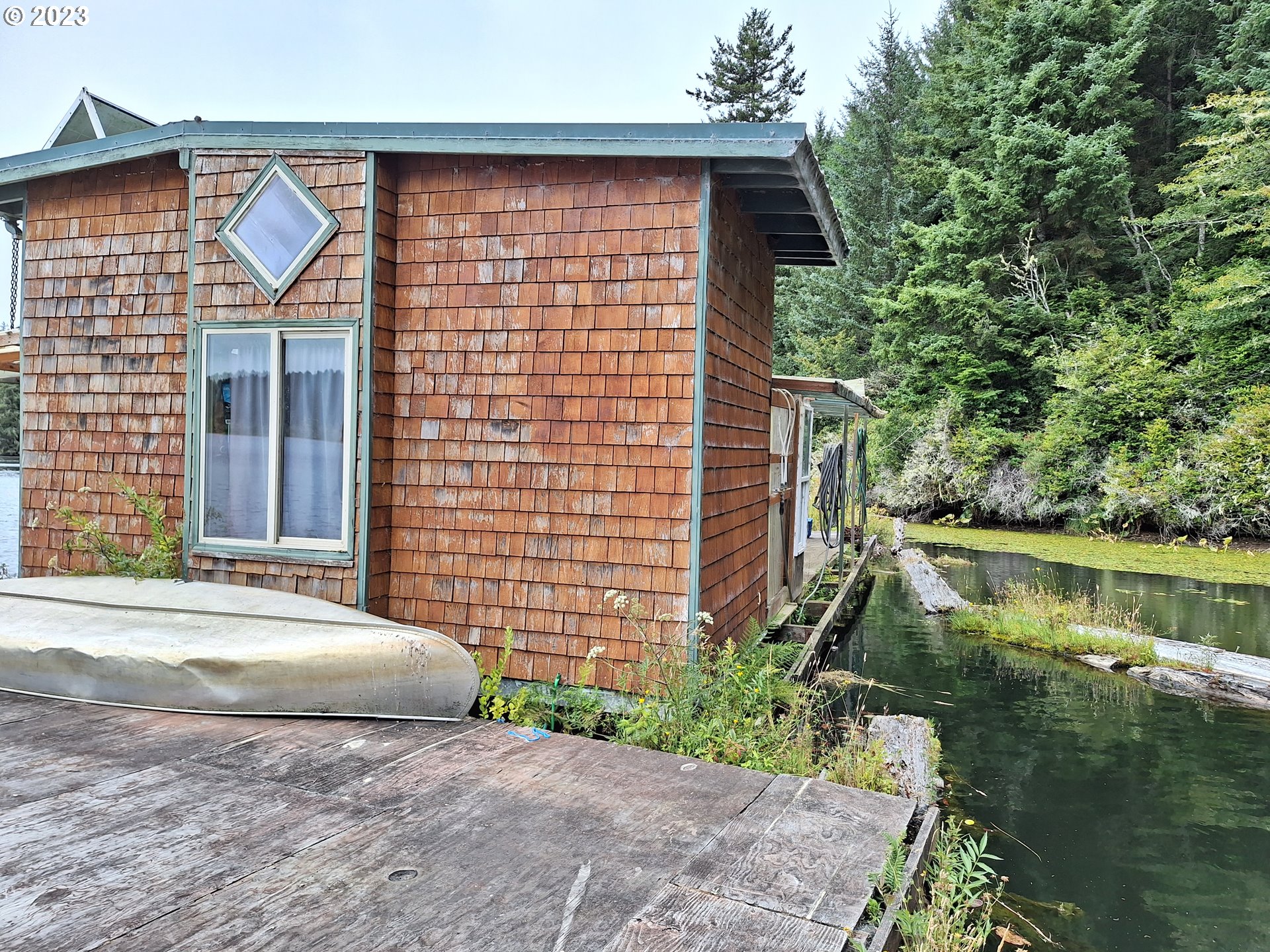 Tahkenitch Gardiner, OR 97441 - Photo 3 of 12 a front view of a house with a yard and potted plants