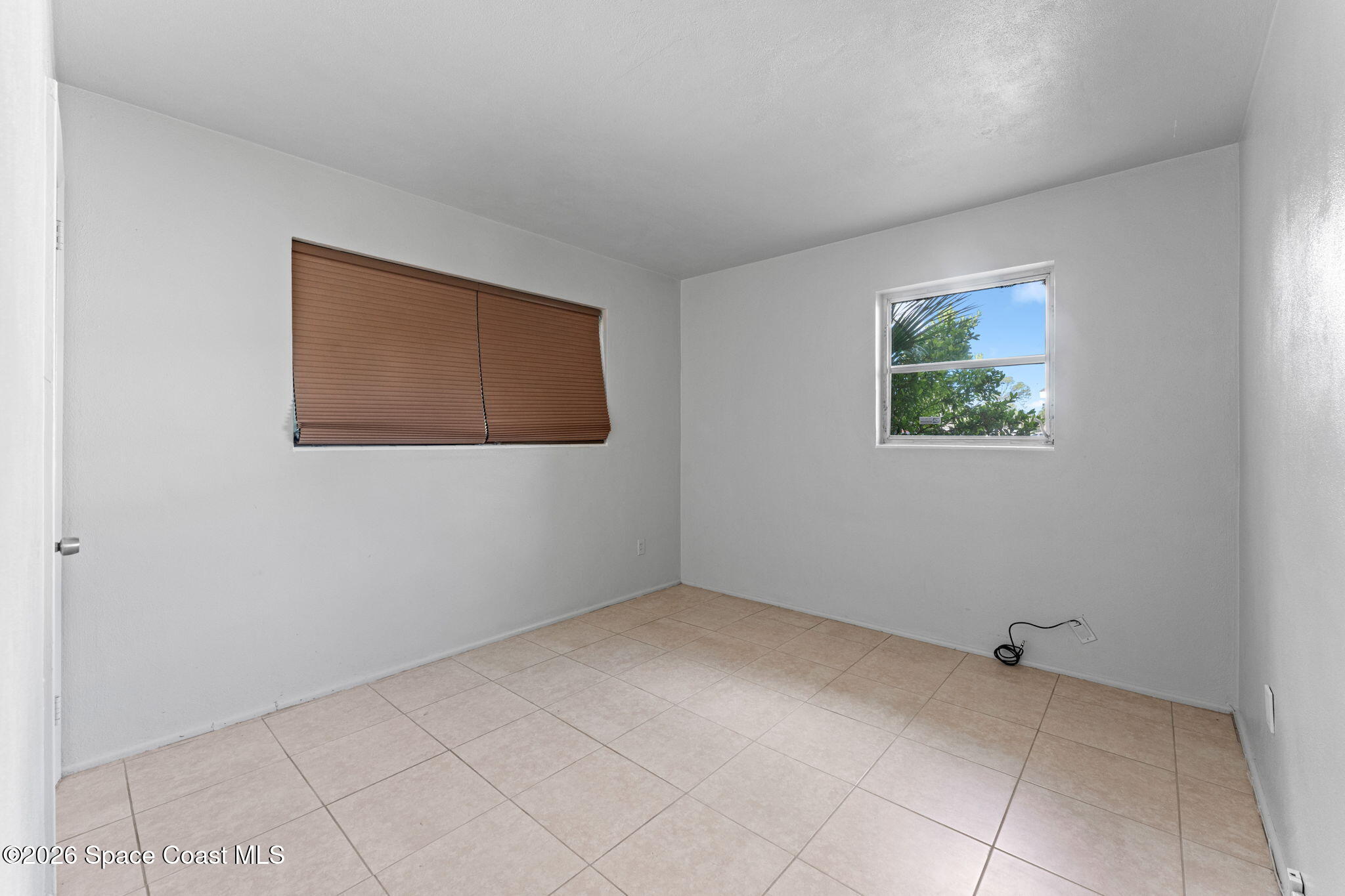 1042 Azalea Lane Cocoa, FL 32922 - Photo 16 of 26 a view of an empty room with a window