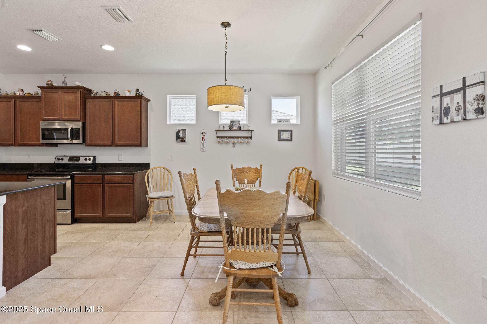 4015 Harvest Circle Rockledge, FL 32955 - Photo 12 of 40 a view of a dining room with furniture and a window