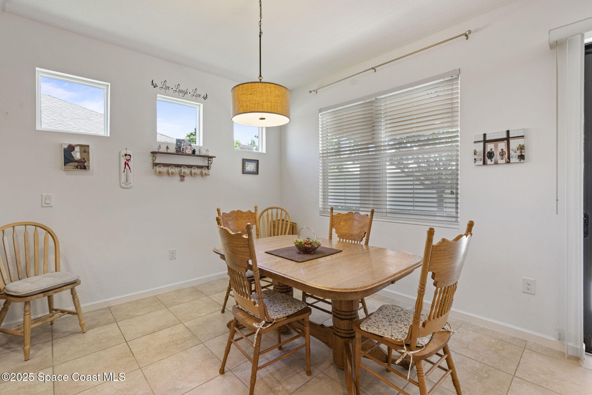 4015 Harvest Circle Rockledge, FL 32955 - Photo 13 of 40 a view of a dining room with furniture and a chandelier