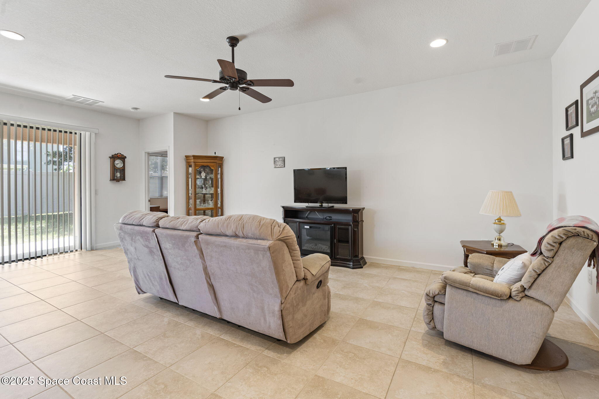 4015 Harvest Circle Rockledge, FL 32955 - Photo 24 of 40 a living room with furniture and a flat screen tv