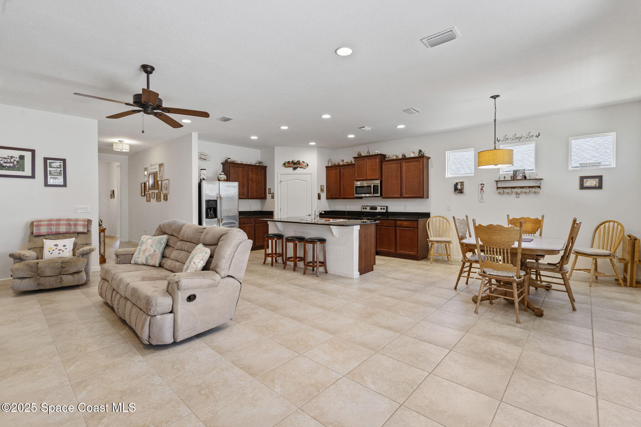 4015 Harvest Circle Rockledge, FL 32955 - Photo 26 of 40 a living room with furniture and kitchen view